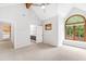 Bright bedroom featuring a vaulted ceiling and large windows with a partial view to the bathroom at 301 Stone Currie Dr, Hillsborough, NC 27278