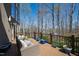Relax on this beautiful deck overlooking the yard with wicker chairs, a wood railing, and lots of sunshine at 301 Stone Currie Dr, Hillsborough, NC 27278