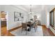 Bright dining room with tray ceilings, hardwood floors, and a big window at 301 Stone Currie Dr, Hillsborough, NC 27278