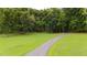 Long winding driveway leads to a private estate surrounded by lush greenery and mature trees at 301 Stone Currie Dr, Hillsborough, NC 27278