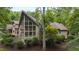Stunning exterior of a luxury home showcasing large windows and beautiful landscaping at 301 Stone Currie Dr, Hillsborough, NC 27278