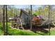 The exterior of this house features a large pitched roof, large glass windows, and a lush green yard with a forest at 301 Stone Currie Dr, Hillsborough, NC 27278