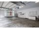 Spacious garage with storage cabinets, tool racks, and ample room for parking vehicles, featuring a clean, organized layout at 301 Stone Currie Dr, Hillsborough, NC 27278
