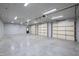 Spacious garage with multiple bay doors, high ceilings, and concrete floor at 301 Stone Currie Dr, Hillsborough, NC 27278