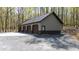 Spacious four-car garage with a durable metal roof, set in a natural wooded setting at 301 Stone Currie Dr, Hillsborough, NC 27278