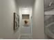 Hallway with stone tile, recessed lighting, and decorative wall art at 301 Stone Currie Dr, Hillsborough, NC 27278