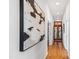 Bright hallway features hardwood floors, artistic decor, and a stained-glass door at 301 Stone Currie Dr, Hillsborough, NC 27278