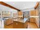 Bright kitchen with granite countertops, stainless appliances, a double island, and views from the windows at 301 Stone Currie Dr, Hillsborough, NC 27278