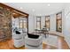 Bright living room with stone accents, hardwood floors and multiple windows at 301 Stone Currie Dr, Hillsborough, NC 27278
