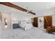 Bright main bedroom with exposed beams, sliding barn door to bathroom, and sitting area at 301 Stone Currie Dr, Hillsborough, NC 27278