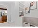 Mudroom/pet station with tiled floor, built-in sink, storage shelves, and pet-themed artwork at 301 Stone Currie Dr, Hillsborough, NC 27278