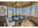 Enclosed porch with wood paneled walls, wood ceiling and beams, fan, and furniture at 301 Stone Currie Dr, Hillsborough, NC 27278