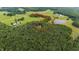 Aerial view with red property line marked, showing house with surrounding meadows and forest at 301 Stone Currie Dr, Hillsborough, NC 27278