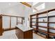 Spacious walk-in closet features custom wood shelving and large center island at 301 Stone Currie Dr, Hillsborough, NC 27278