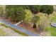 Bird's eye view of the residence with a road in the foreground and verdant trees at 3026 Shoeheel Rd, Kenly, NC 27542