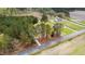 Aerial view showing a home nestled among trees with other residences nearby at 3026 Shoeheel Rd, Kenly, NC 27542