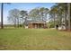 Charming brick home with a spacious backyard and additional outbuilding at 3026 Shoeheel Rd, Kenly, NC 27542