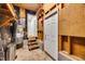 Unfinished basement with water heater, shelving, and access to a finished room at 3026 Shoeheel Rd, Kenly, NC 27542
