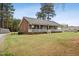 Welcoming single-story home featuring a large front porch, neat lawn, and attractive brick and siding exterior at 3026 Shoeheel Rd, Kenly, NC 27542