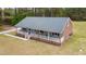 Charming single-story home featuring a welcoming porch, neutral siding and brick accents, set in a wooded area at 3026 Shoeheel Rd, Kenly, NC 27542