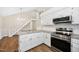 Well-lit kitchen with stainless steel appliances, granite countertops, and adjacent stairway at 3026 Shoeheel Rd, Kenly, NC 27542
