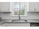 Close up of kitchen sink with window overlooking trees at 3026 Shoeheel Rd, Kenly, NC 27542