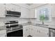 Charming kitchen features subway tile, stainless steel appliances, and granite countertops at 3026 Shoeheel Rd, Kenly, NC 27542