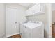 Laundry room with white appliances, cabinets, and door at 3026 Shoeheel Rd, Kenly, NC 27542