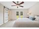Bright main bedroom featuring a ceiling fan, sliding barn door and backyard access at 3026 Shoeheel Rd, Kenly, NC 27542