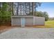 Exterior of the home's outbuilding features durable siding and a secure entry door at 3026 Shoeheel Rd, Kenly, NC 27542