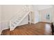 Bright staircase with modern chandelier, hardwood floors and neutral walls at 3026 Shoeheel Rd, Kenly, NC 27542