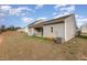 Spacious backyard with green grass and a covered patio, perfect for outdoor entertaining at 303 Azalea Gaze Dr, Youngsville, NC 27596