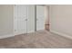 Bedroom view highlighting carpet floors, closet, and an open doorway to another room at 303 Azalea Gaze Dr, Youngsville, NC 27596