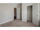 Bedroom with closet view, plush carpeting, and open doorway for flexible space utilization at 303 Azalea Gaze Dr, Youngsville, NC 27596