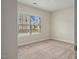 Neutral bedroom featuring a window that provides natural light and a view of the neighborhood at 303 Azalea Gaze Dr, Youngsville, NC 27596