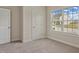 Bright bedroom with carpet floors, large window, and closet perfect for a guest room at 303 Azalea Gaze Dr, Youngsville, NC 27596
