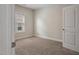 Bedroom with large window for natural light, carpet flooring, and neutral paint at 303 Azalea Gaze Dr, Youngsville, NC 27596