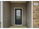 Close-up of the front door with stone details and prominent house number, adding character and curb appeal at 303 Azalea Gaze Dr, Youngsville, NC 27596