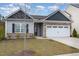 Traditional single-story home featuring stone accents and a two-car garage at 303 Azalea Gaze Dr, Youngsville, NC 27596