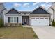 Charming single-story home featuring stone accents and a two-car garage at 303 Azalea Gaze Dr, Youngsville, NC 27596