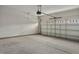 Clean garage with concrete flooring and a partially open garage door at 303 Azalea Gaze Dr, Youngsville, NC 27596