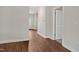 Bright hallway with wood-look flooring and white trim, leading to a welcoming entrance, highlighting the home's layout at 303 Azalea Gaze Dr, Youngsville, NC 27596