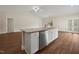 Kitchen island featuring stainless steel dishwasher, granite countertop, and white cabinetry, enhancing functionality and design at 303 Azalea Gaze Dr, Youngsville, NC 27596