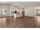 Open-concept living area featuring a modern kitchen with stainless steel appliances and a seamless flow to the living space at 303 Azalea Gaze Dr, Youngsville, NC 27596