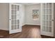 Bright office with French doors and large window offers a view of the front yard at 303 Azalea Gaze Dr, Youngsville, NC 27596