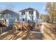 Rear view of the home showcasing a spacious wooden deck and a well-maintained backyard at 306 Cecil St, Durham, NC 27707