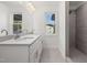 Bathroom with double sink vanity, a large mirror and tiled shower at 306 Cecil St, Durham, NC 27707