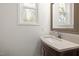 Bathroom vanity with modern sink, framed mirror and a window that brings in natural light at 306 Cecil St, Durham, NC 27707