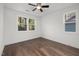 Light-filled bedroom with hardwood floors, ceiling fan, and a view to the outdoors at 306 Cecil St, Durham, NC 27707