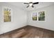 Bedroom with wood floors and two windows that bring in natural light at 306 Cecil St, Durham, NC 27707
